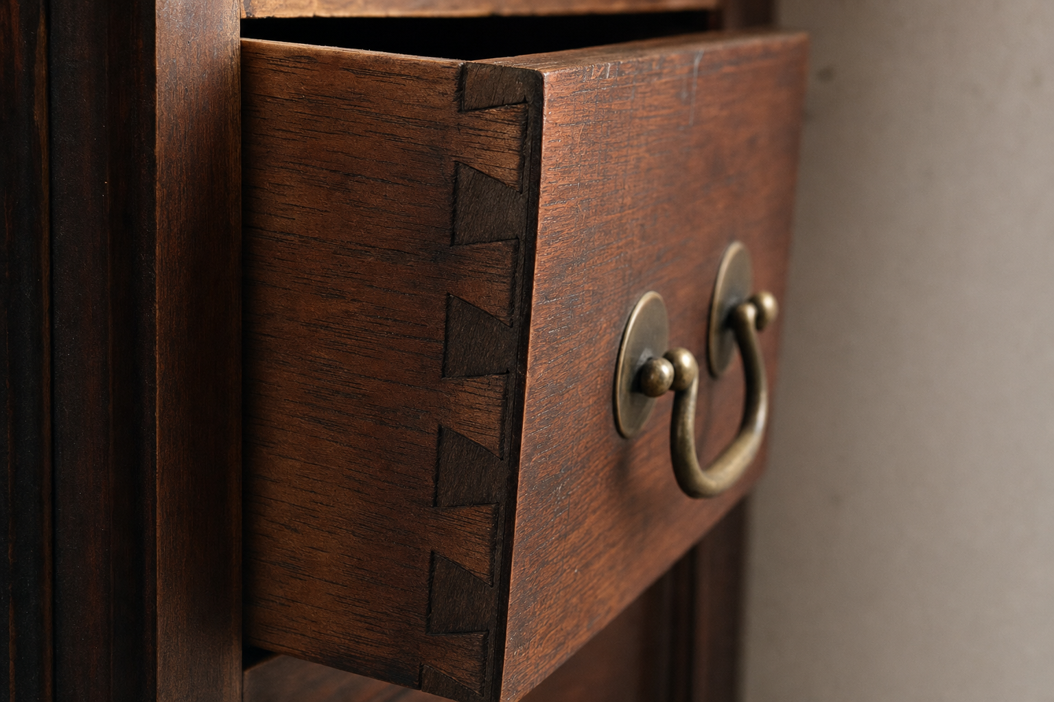 Hand-cut dovetail joinery on a Federal-period drawer corner showing wide pin and narrow tail pattern with visible saw marks