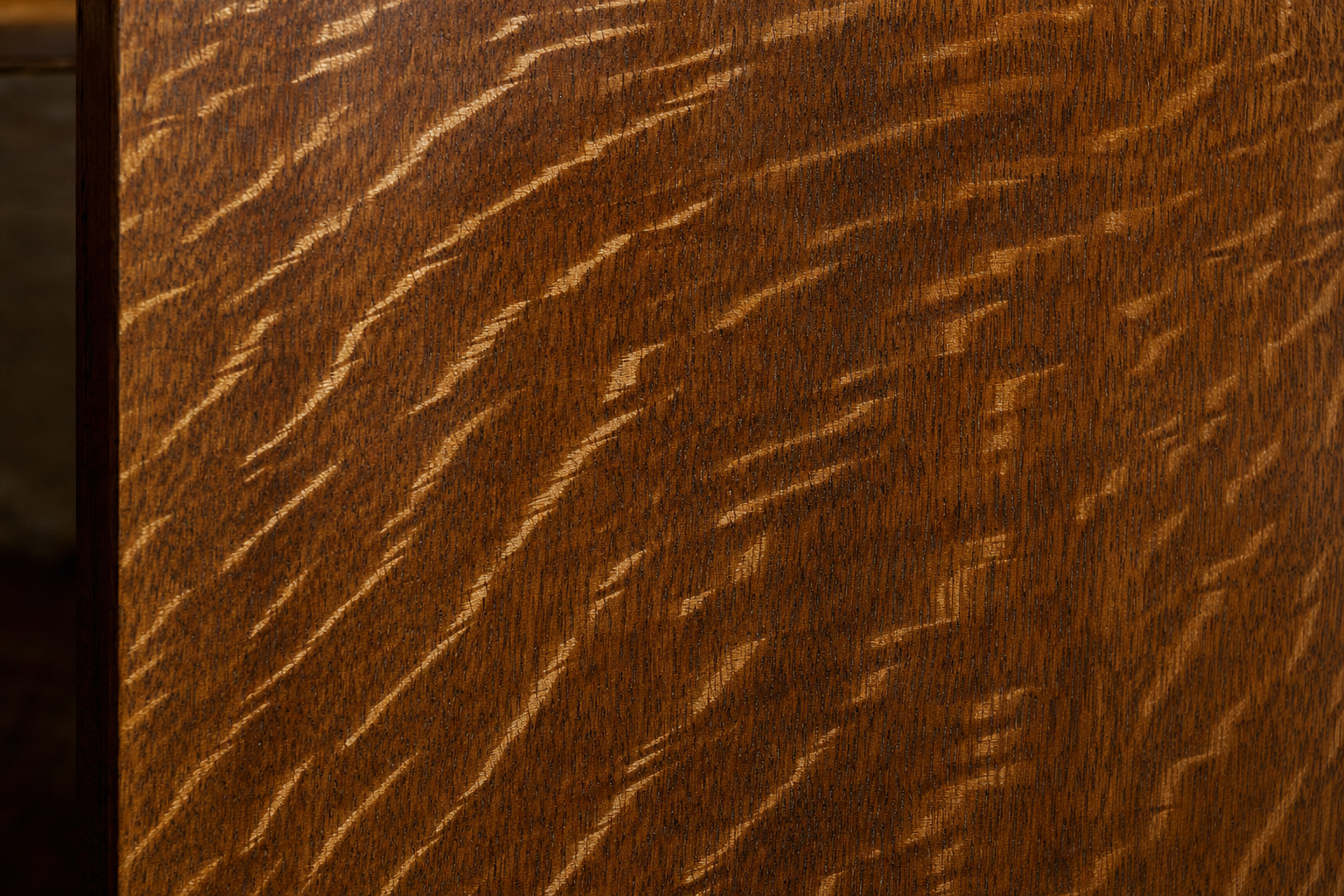 Macro close-up of quarter-sawn white oak showing prominent tiger-grain medullary rays catching light